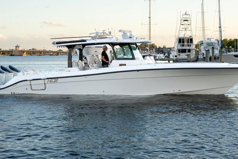  Yacht Photos Pics 2024 HCB 42 Lujo boat cruising on calm waters near a marina.