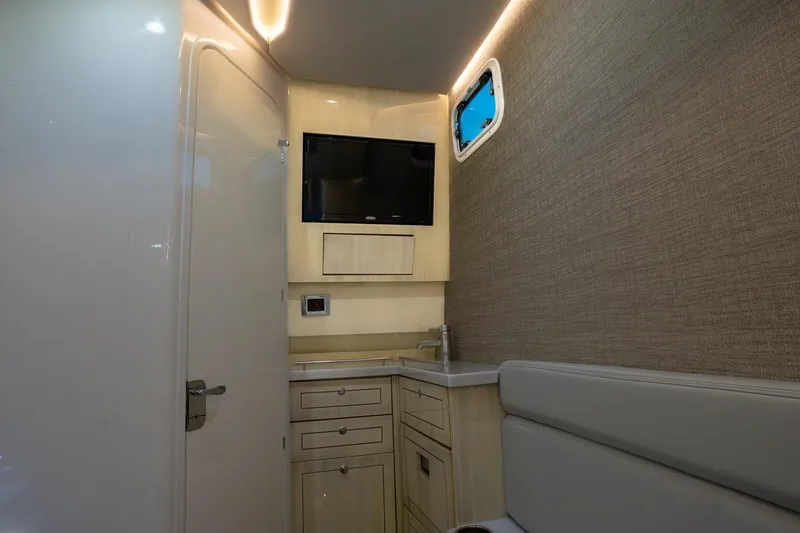  Yacht Photos Pics Interior of 2024 HCB 42 Lujo boat with TV, sink, and seating area.