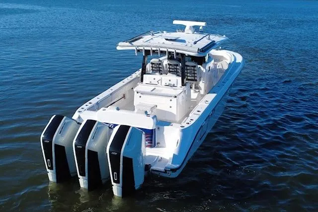  Yacht Photos Pics 2024 HCB 42 Lujo boat with triple outboard engines on open water.