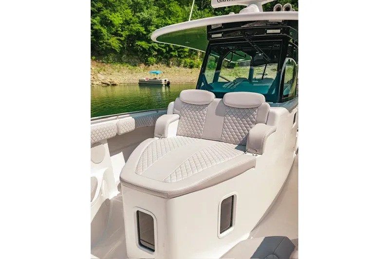  Yacht Photos Pics 2024 HCB 42 Lujo boat with luxurious seating, docked by a scenic lakeside.