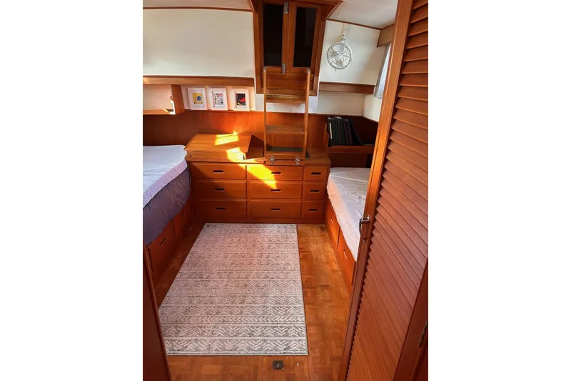 Tiger Moth (reserved) Yacht Photos Pics 1984 Grand Banks 42 Classic cabin interior with wooden furnishings and twin beds.