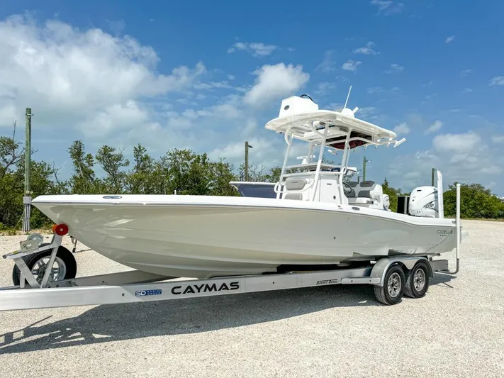  Yacht Photos Pics 2024 Caymas 28 HB boat on trailer, parked outdoors under a clear blue sky.