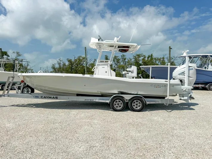  Yacht Photos Pics 2024 Caymas 28 HB boat on trailer, parked outdoors under a cloudy sky.