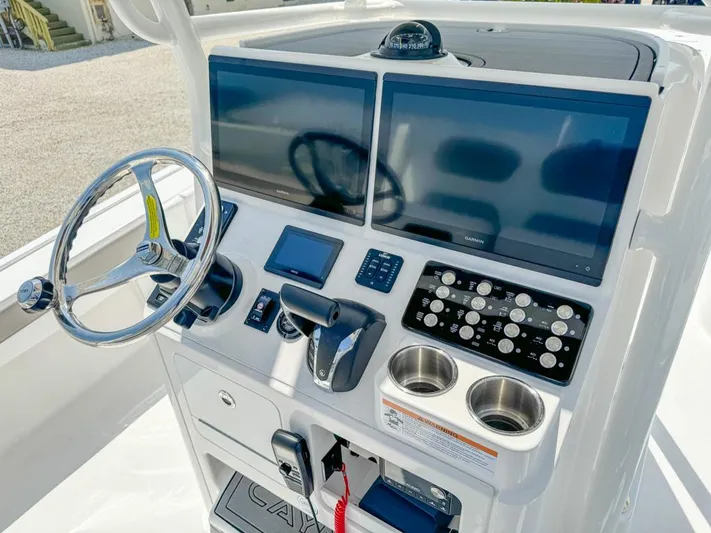  Yacht Photos Pics 2024 Caymas 28 HB boat dashboard with dual screens, steering wheel, and control panel.