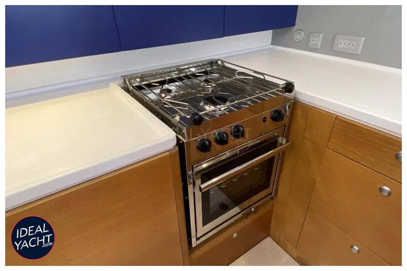 Mary Blue 3 Yacht Photos Pics Modern yacht kitchen with stainless steel stove, wooden cabinets, and white countertops on a Garcia 65ft yacht.