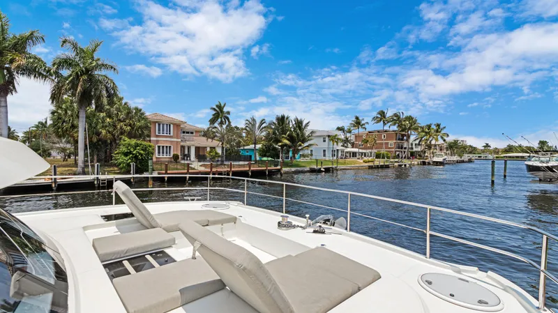 A New Hope Yacht Photos Pics Fountaine Pajot MY 44 yacht, 2018 model, docked near waterfront homes and palm trees.