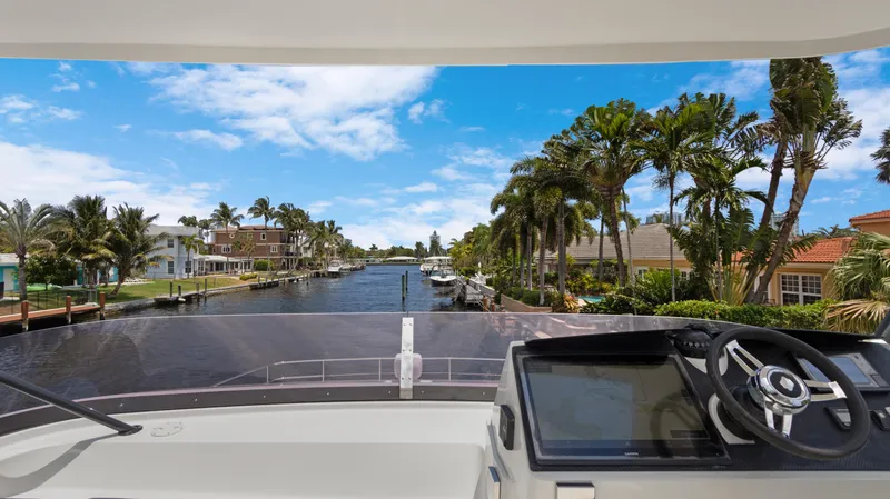 A New Hope Yacht Photos Pics View from 2018 Fountaine Pajot MY 44 yacht, overlooking a scenic canal with palm trees.