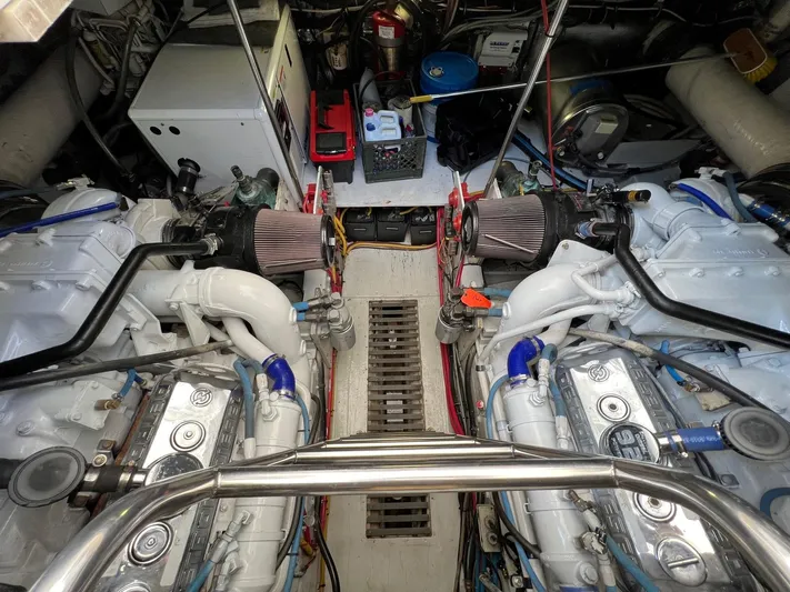 Chaos Yacht Photos Pics Engine room of a 1996 Tiara Yachts 4300 Open, showcasing dual engines and mechanical components.