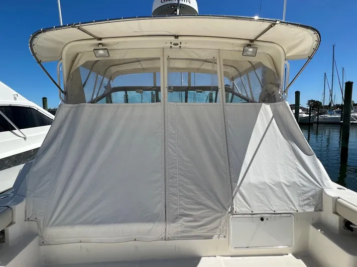 Chaos Yacht Photos Pics 1996 Tiara Yachts 4300 Open with covered cockpit, docked at marina.