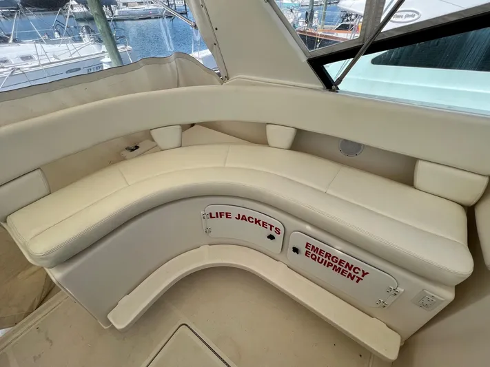 Chaos Yacht Photos Pics 1996 Tiara Yachts 4300 Open interior with white seating and safety equipment storage.