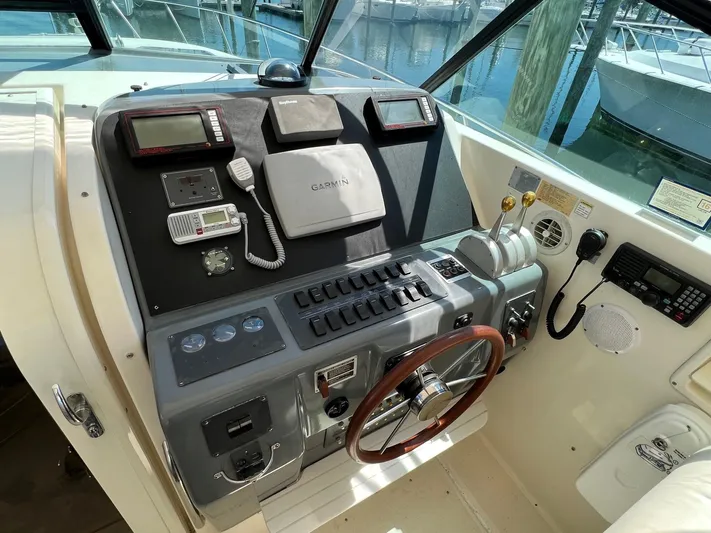 Chaos Yacht Photos Pics 1996 Tiara Yachts 4300 Open helm with Garmin navigation, steering wheel, and control panel.