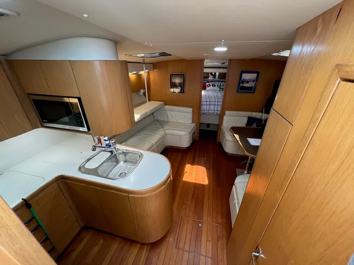 Chaos Yacht Photos Pics Interior of 1996 Tiara Yachts 4300 Open with wood finish and modern amenities.