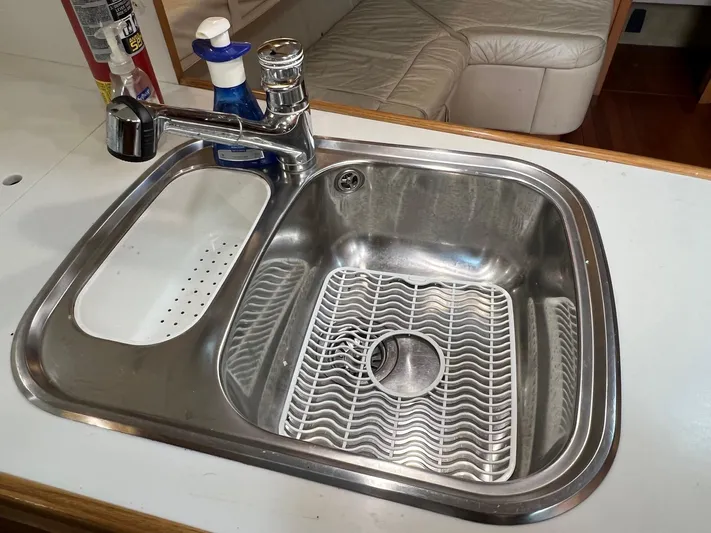 Chaos Yacht Photos Pics Stainless steel sink in 1996 Tiara Yachts 4300 Open, featuring modern faucet and accessories.