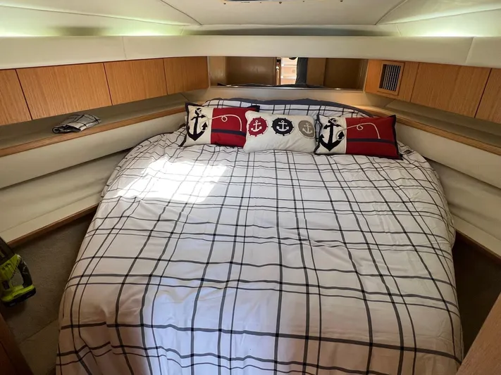 Chaos Yacht Photos Pics 1996 Tiara Yachts 4300 Open cabin with plaid bedding and nautical-themed pillows.