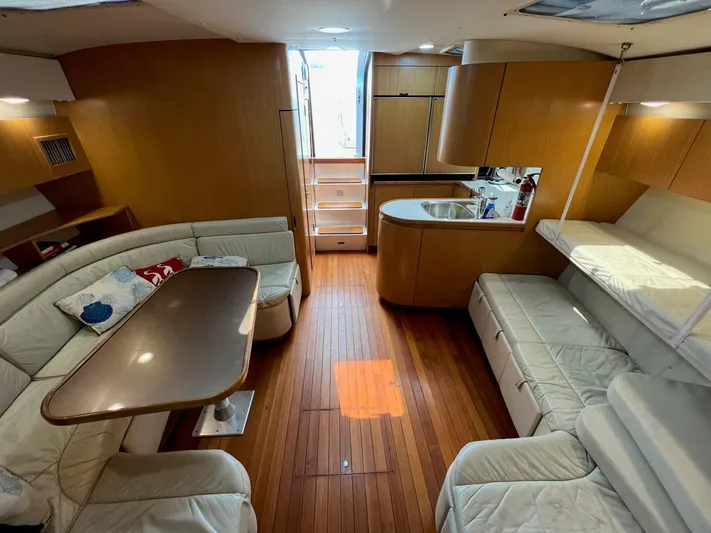 Chaos Yacht Photos Pics 1996 Tiara Yachts 4300 Open interior with wood flooring, seating, and kitchenette.