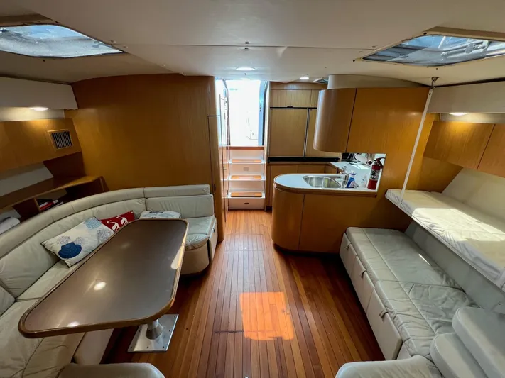 Chaos Yacht Photos Pics Interior of 1996 Tiara Yachts 4300 Open with wood flooring and cozy seating area.