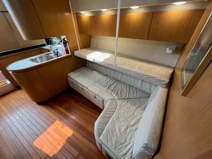 Chaos Yacht Photos Pics 1996 Tiara Yachts 4300 Open interior with wooden flooring and cozy seating area.