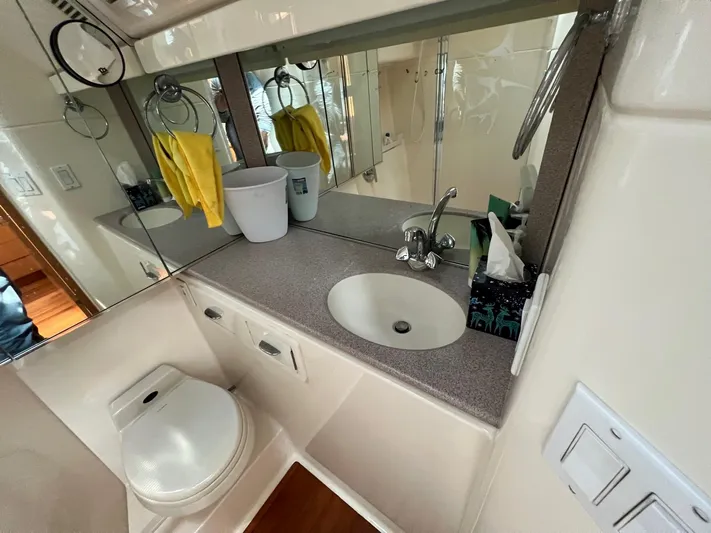 Chaos Yacht Photos Pics Bathroom interior of 1996 Tiara Yachts 4300 Open, featuring sink and toilet.