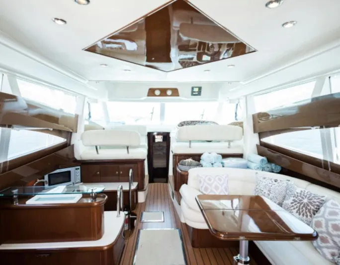  Yacht Photos Pics Luxurious interior of 2003 Jeanneau Prestige 46 yacht with elegant wood finishes and seating.
