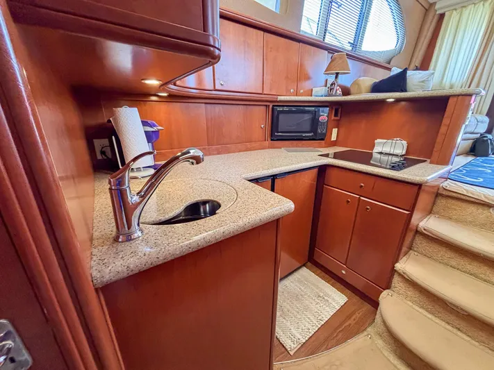 Sea Marie Yacht Photos Pics Luxurious 2007 Silverton 38 Convertible yacht kitchen with modern amenities and elegant wood finish.