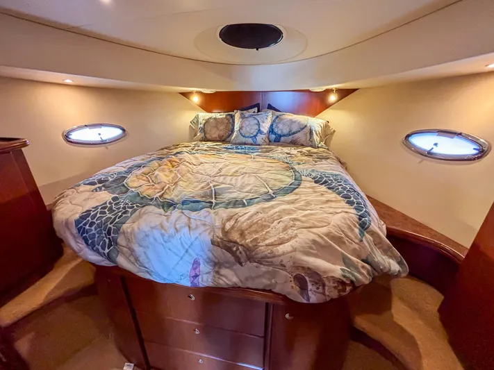 Sea Marie Yacht Photos Pics Luxurious 2007 Silverton 38 Convertible yacht bedroom with cozy bedding and elegant wood finishes.