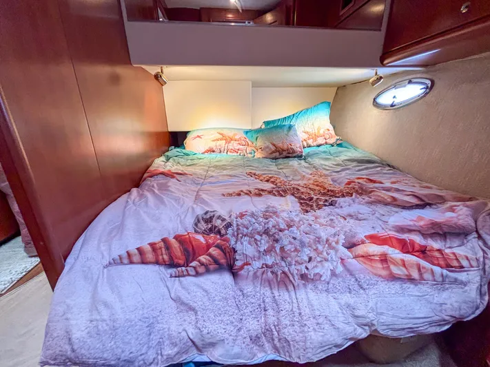 Sea Marie Yacht Photos Pics Cozy bedroom in 2007 Silverton 38 Convertible yacht with ocean-themed bedding.