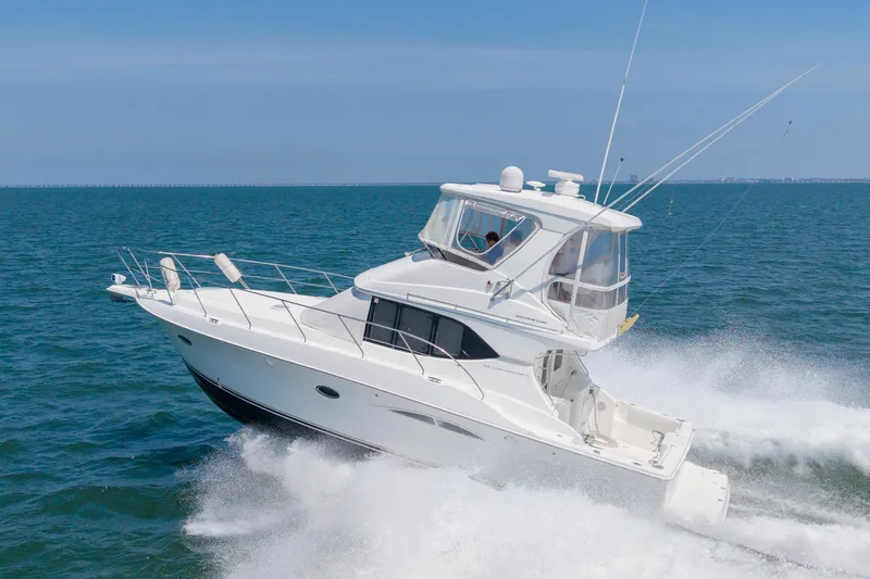 Sea Marie Yacht Photos Pics 2007 Silverton 38 Convertible yacht cruising on open sea, creating waves.
