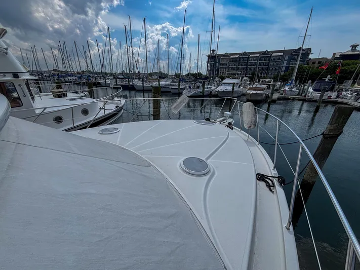 Sea Marie Yacht Photos Pics 2007 Silverton 38 Convertible yacht docked in a marina under a partly cloudy sky.
