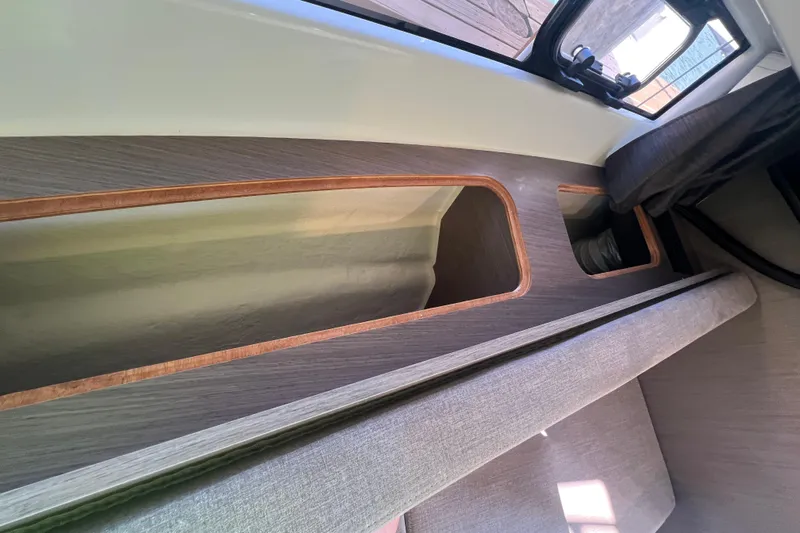  Yacht Photos Pics Interior view of 2024 Beneteau Flyer 9 SUNdeck, showcasing sleek wood and fabric design.