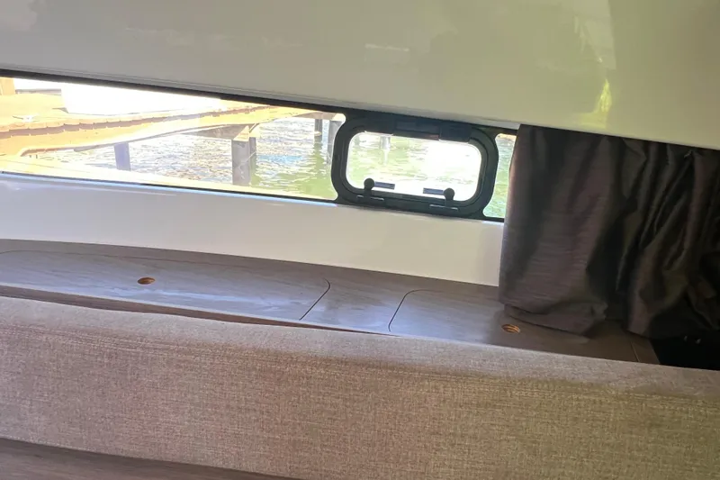  Yacht Photos Pics Interior view of 2024 Beneteau Flyer 9 SUNdeck with window and curtain.