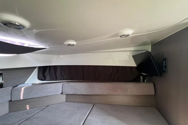  Yacht Photos Pics 2024 Beneteau Flyer 9 SUNdeck interior cabin with seating and mounted TV.