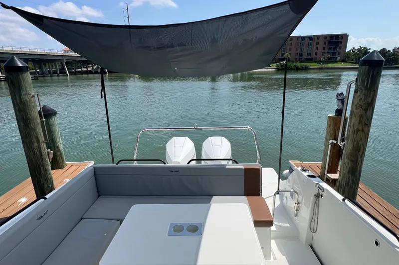  Yacht Photos Pics 2024 Beneteau Flyer 9 SUNdeck at dock, featuring spacious seating and dual engines.