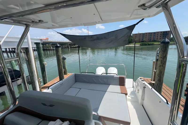  Yacht Photos Pics 2024 Beneteau Flyer 9 SUNdeck boat with spacious seating and waterfront view.