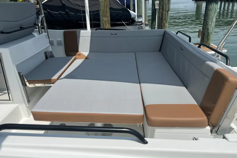  Yacht Photos Pics 2024 Beneteau Flyer 9 SUNdeck boat seating area with gray and brown cushions.
