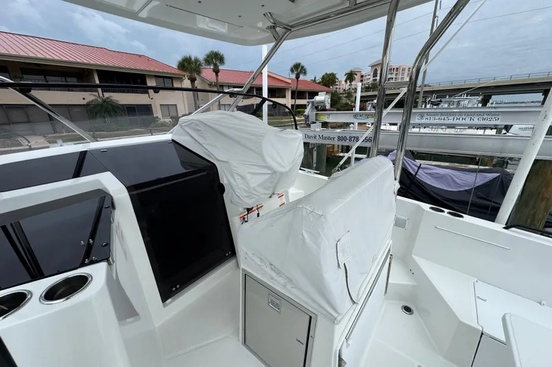  Yacht Photos Pics 2024 Beneteau Flyer 9 SUNdeck boat interior with covered seating and helm station.