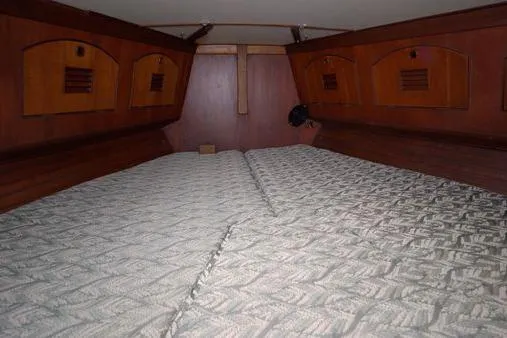  Yacht Photos Pics 1984 Little Harbor LH44 cabin interior with wooden storage and patterned bedding.