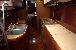  Yacht Photos Pics 1984 Little Harbor LH44 yacht interior with wooden cabinetry and kitchen amenities.