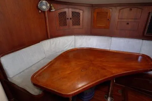  Yacht Photos Pics 1984 Little Harbor LH44 yacht interior with wooden table and cushioned seating.