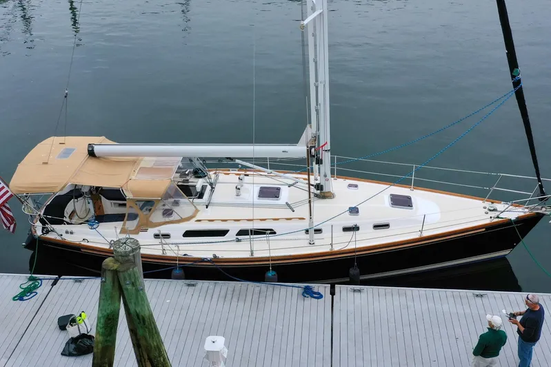Jezebel Yacht Photos Pics 2004 Sabre 426 sailboat docked, featuring tan canopy and sleek design.