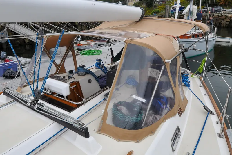 Jezebel Yacht Photos Pics 2004 Sabre 426 sailboat with tan canopy docked at marina.