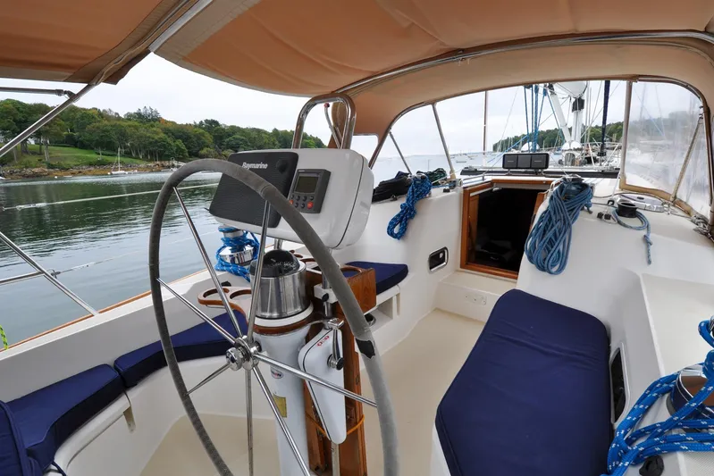Jezebel Yacht Photos Pics Cockpit of 2004 Sabre 426 sailboat with steering wheel and navigation equipment.