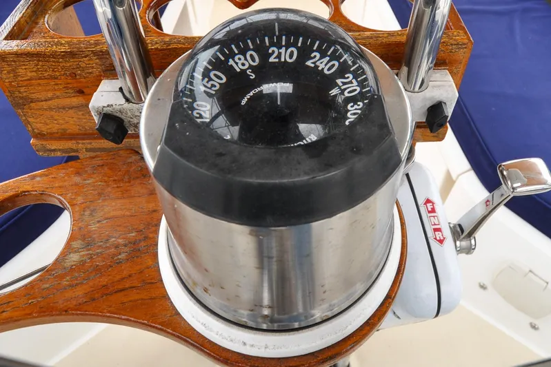 Jezebel Yacht Photos Pics Compass and throttle on 2004 Sabre 426 yacht, featuring wooden and metal elements.