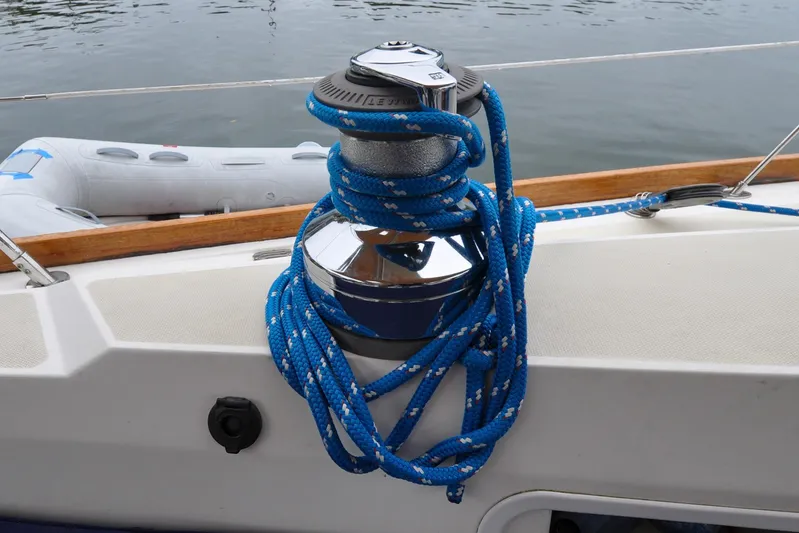 Jezebel Yacht Photos Pics Blue rope on winch aboard 2004 Sabre 426 sailboat, with inflatable dinghy in background.