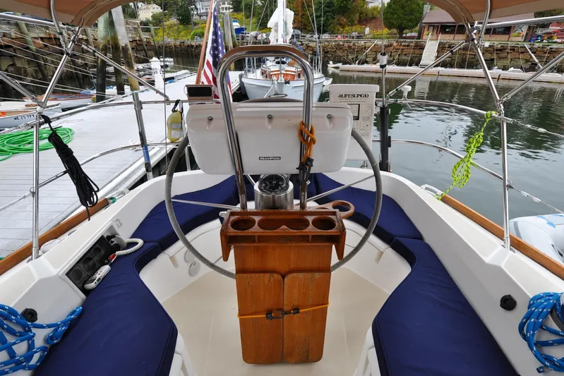 Jezebel Yacht Photos Pics Cockpit of 2004 Sabre 426 sailboat docked, featuring steering wheel and seating area.