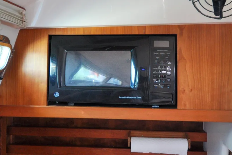Jezebel Yacht Photos Pics Black GE microwave in wooden cabinet on 2004 Sabre 426 yacht.
