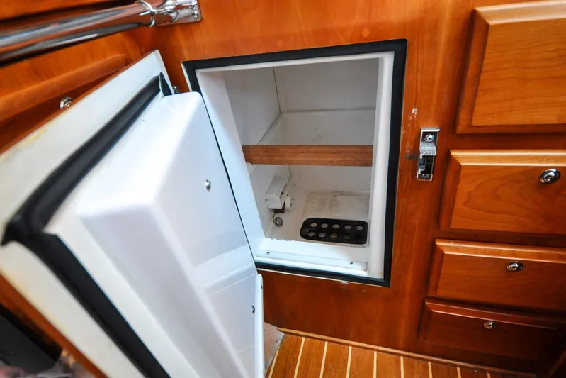 Jezebel Yacht Photos Pics Open refrigerator in 2004 Sabre 426 yacht with wooden cabinetry.