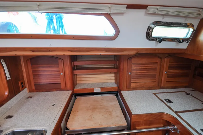 Jezebel Yacht Photos Pics 2004 Sabre 426 yacht interior with wooden cabinets and countertop.