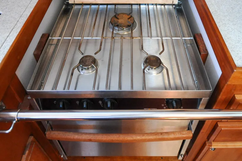 Jezebel Yacht Photos Pics Three-burner stainless steel stove in a 2004 Sabre 426 yacht kitchen.