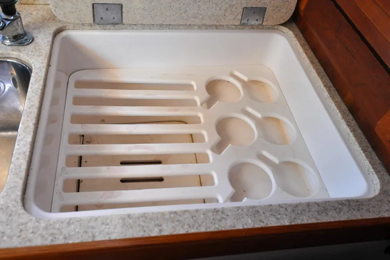 Jezebel Yacht Photos Pics White sink with integrated dish rack in a 2004 Sabre 426 yacht kitchen.