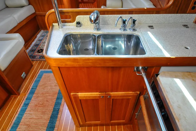 Jezebel Yacht Photos Pics Luxurious Sabre 426 yacht kitchen with double sink, wooden cabinetry, and elegant flooring, 2004 model.
